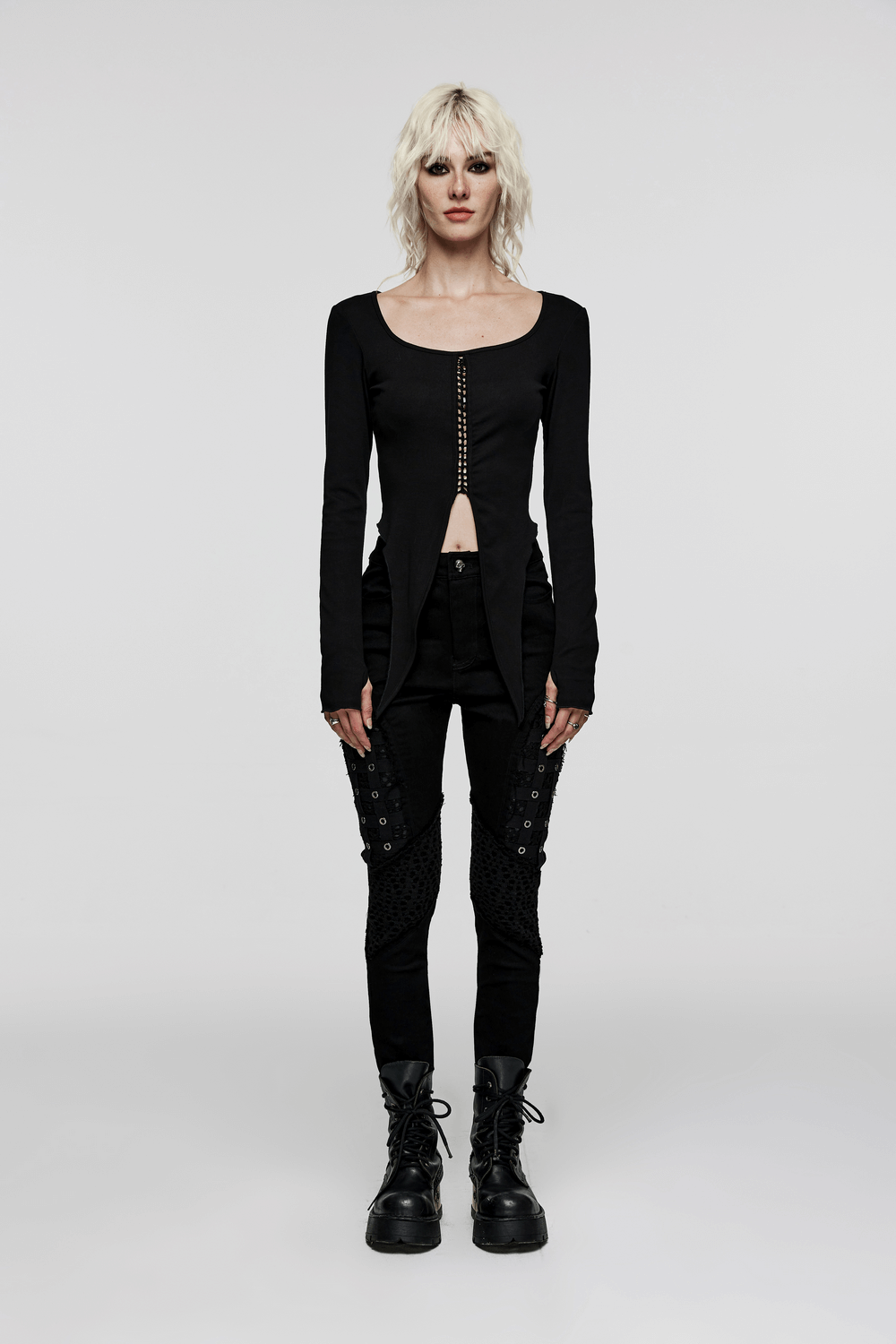 Chic black rubberized mesh punk skinny pants for women, featuring edgy design with geometric eyelet webbing.