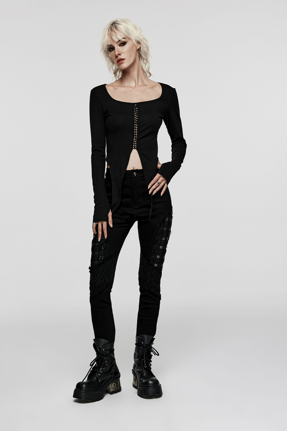 Chic black rubberized mesh punk skinny pants for women, featuring edgy design and geometric eyelet detailing.