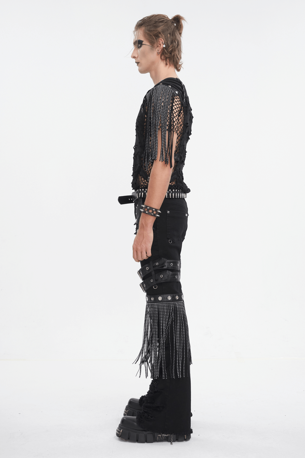 Trendy model showcasing chic black studded ripped jeans with bold buckle details and edgy accessories.