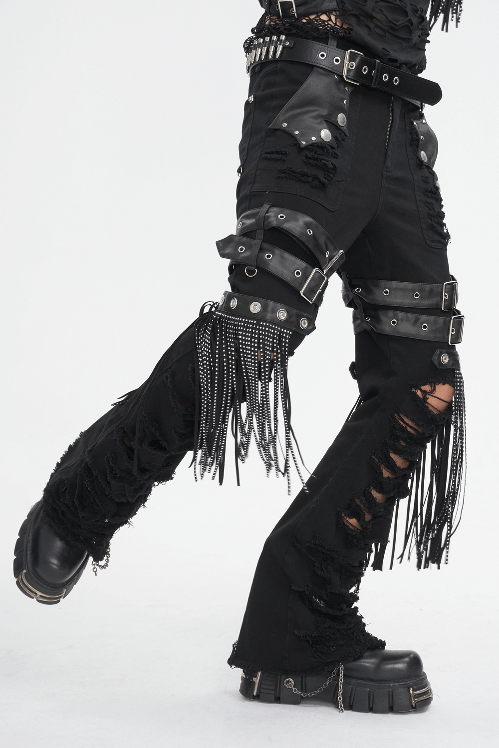 Trendy black studded ripped jeans with buckle details and fringe, perfect for edgy fashion lovers.