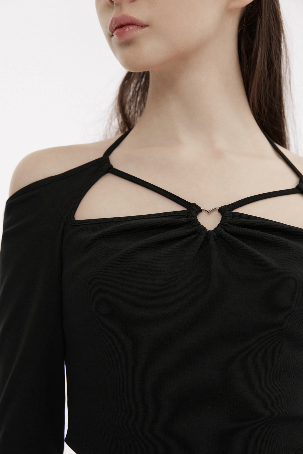 Chic black off-the-shoulder top featuring sweetheart neckline and heart detail, perfect for a stylish night out.