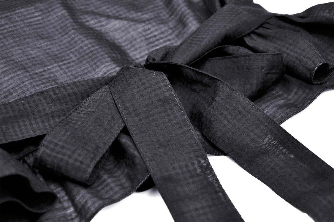 Close-up of black ruffled lace top with elegant ribbons, perfect for gothic fashion enthusiasts.