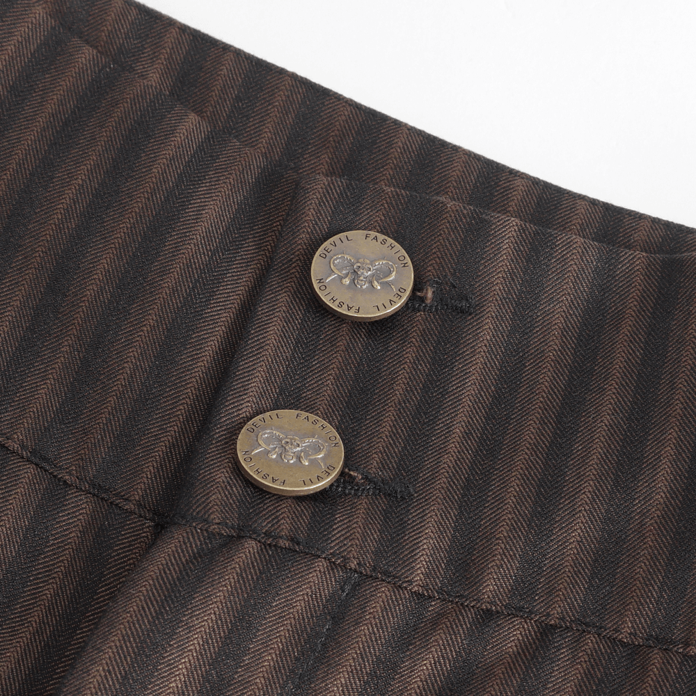 Close-up of chic brown striped trousers featuring decorative buttons and tailored design elements.