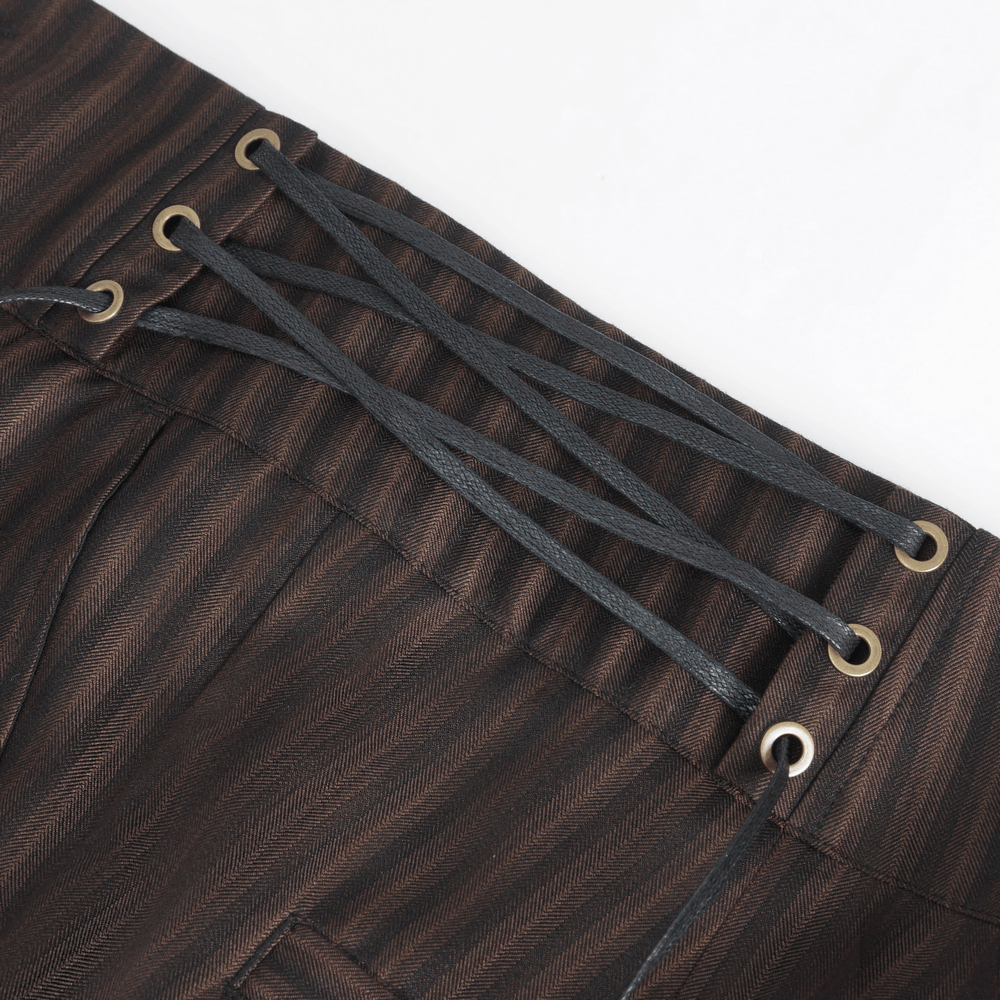 Close-up of chic brown striped trousers showcasing stylish lace-up sides with grommets.