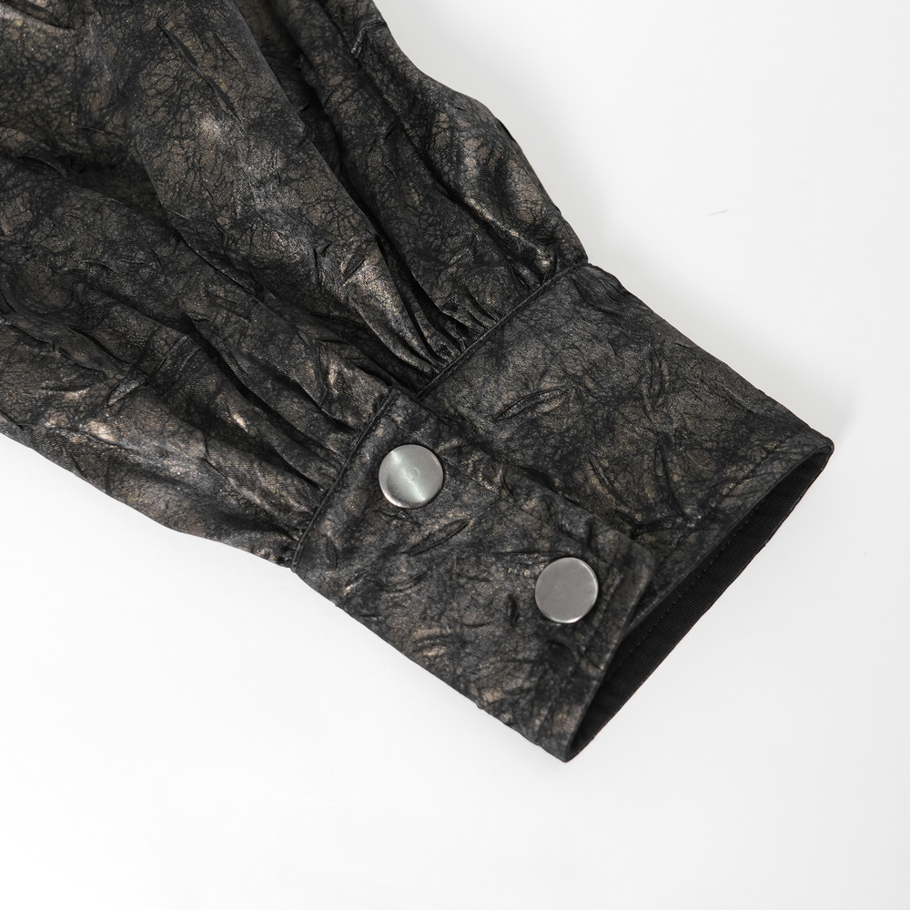 Close-up of chic balloon sleeve with faux leather texture and button details on a punk rock shirt.