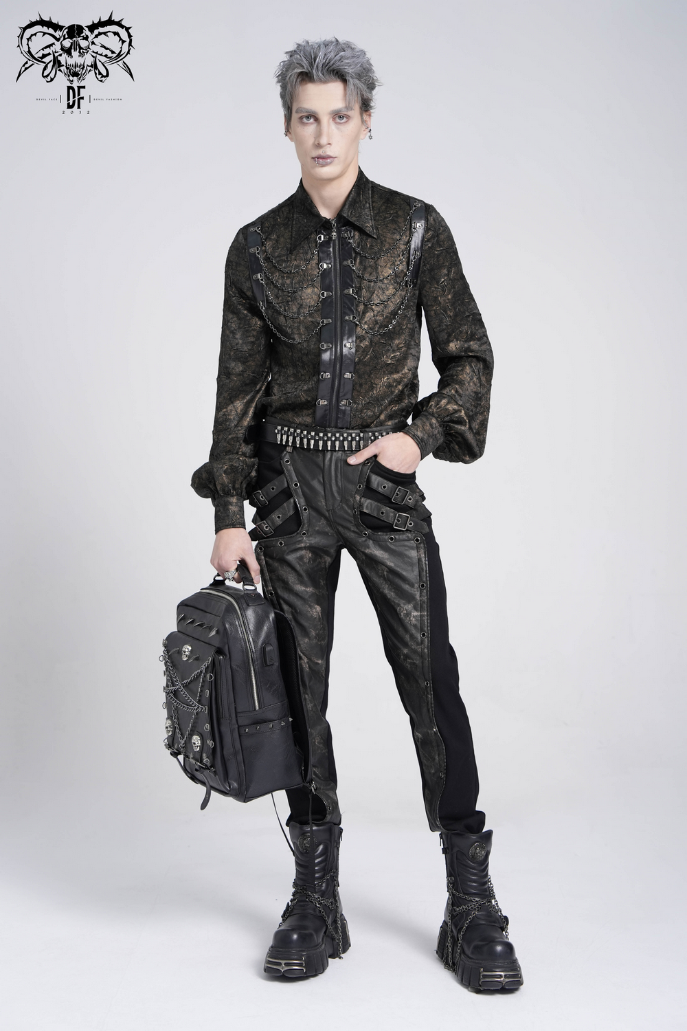 Fashion-forward model sporting a chic chain shirt with faux leather straps, styled for a punk rock aesthetic.