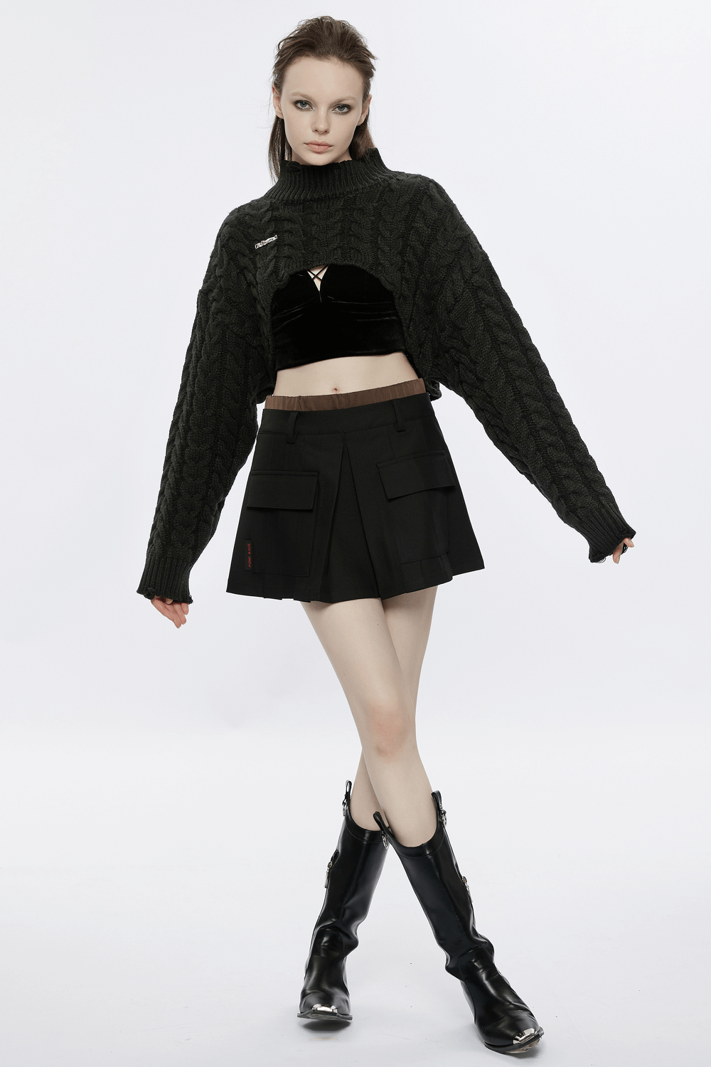 Chic cropped black knit turtleneck sweater styled with a black skirt and tall boots, perfect for trendy autumn outfits.
