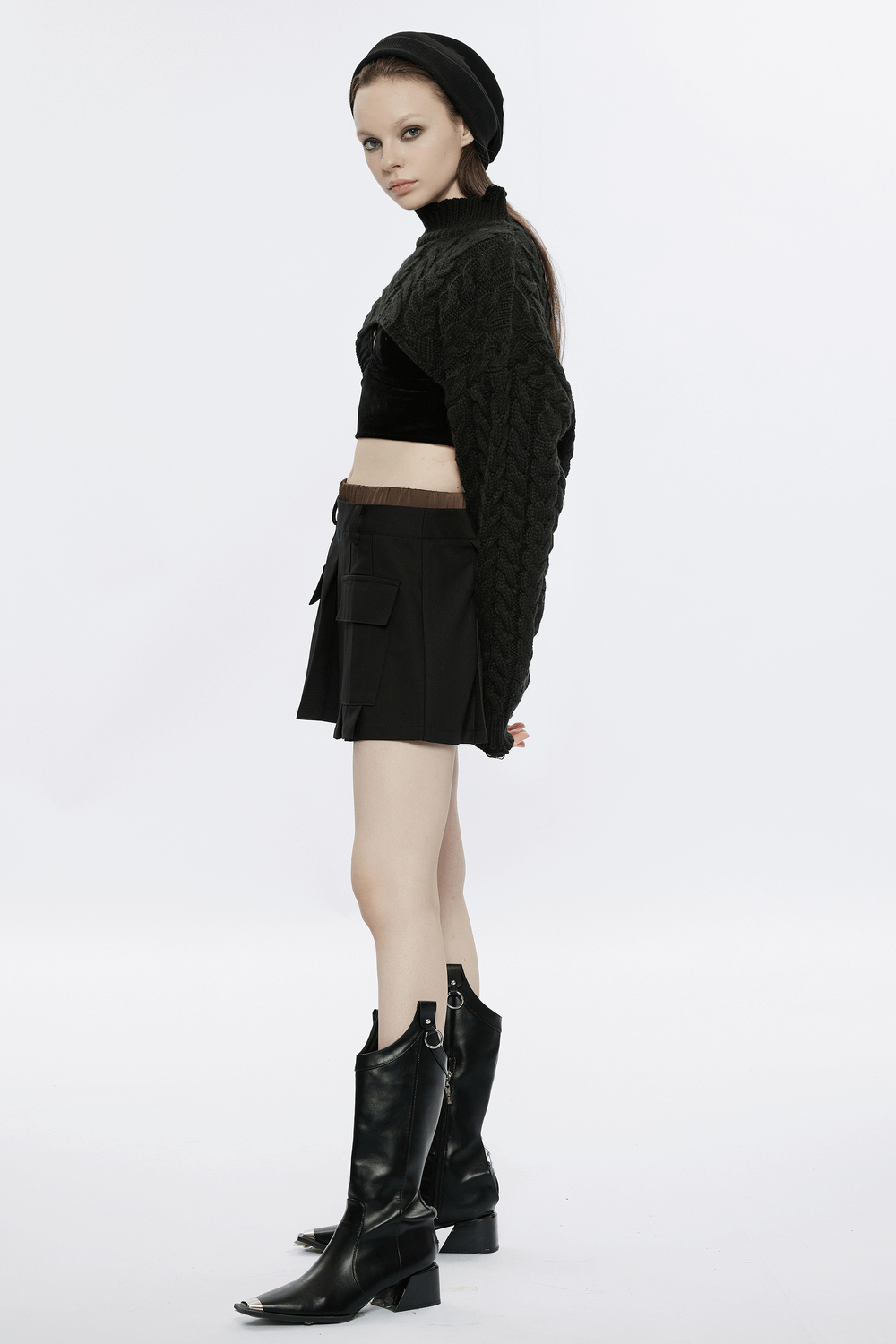 Trendy black cropped knit turtleneck sweater paired with stylish shorts and knee-high boots.
