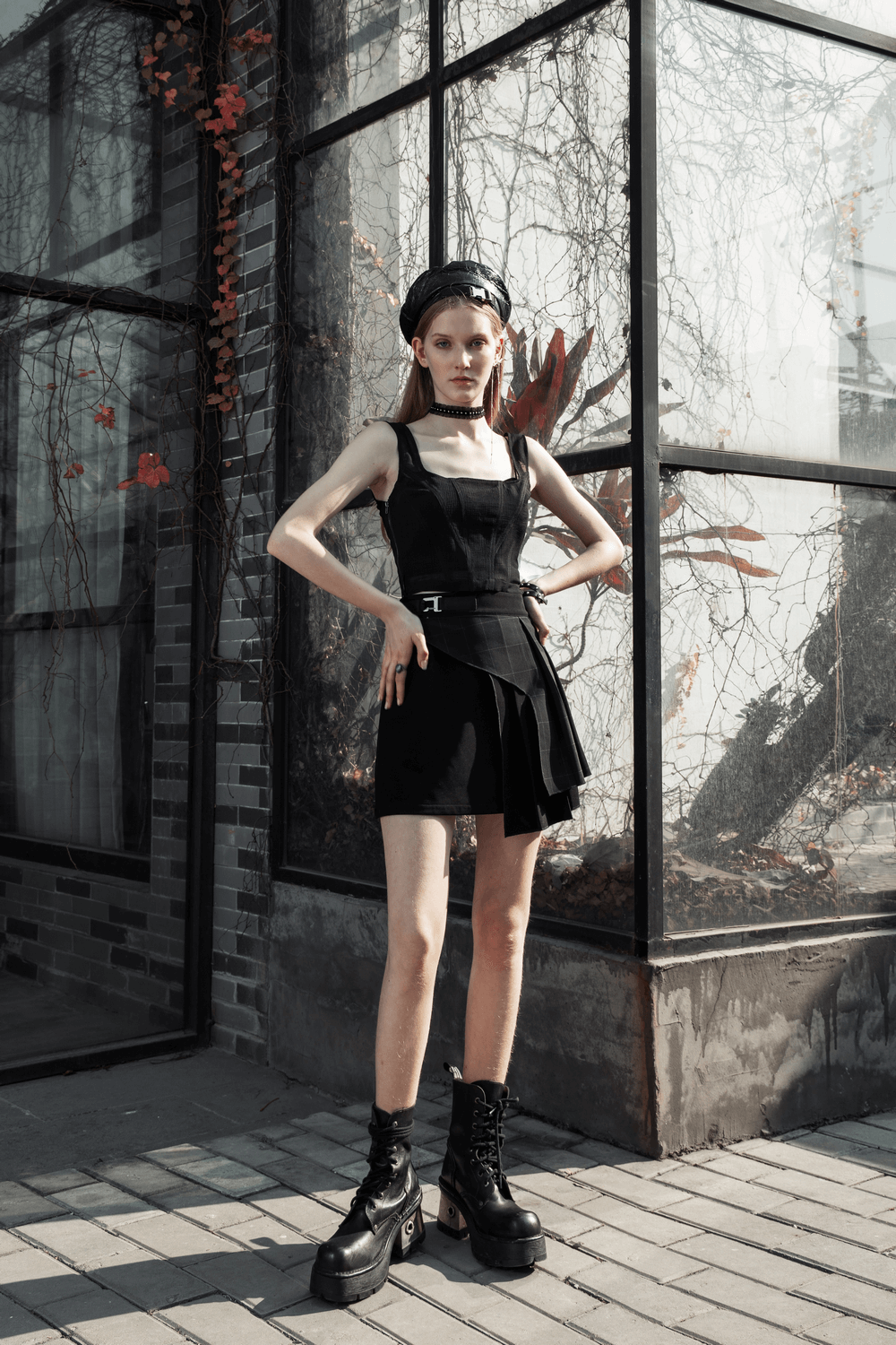 Model wearing a chic dark plaid mesh top with detachable belt, showcasing elegance and style against a modern backdrop.