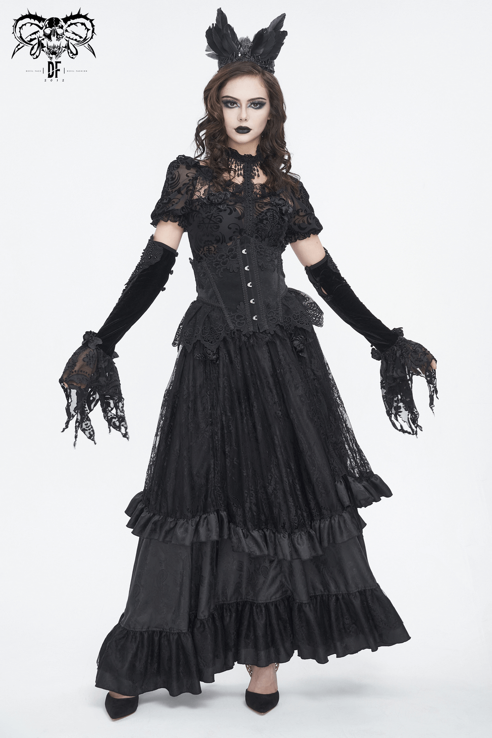 Elegant gothic model in a black lace corset dress with long gloves and ornate details.