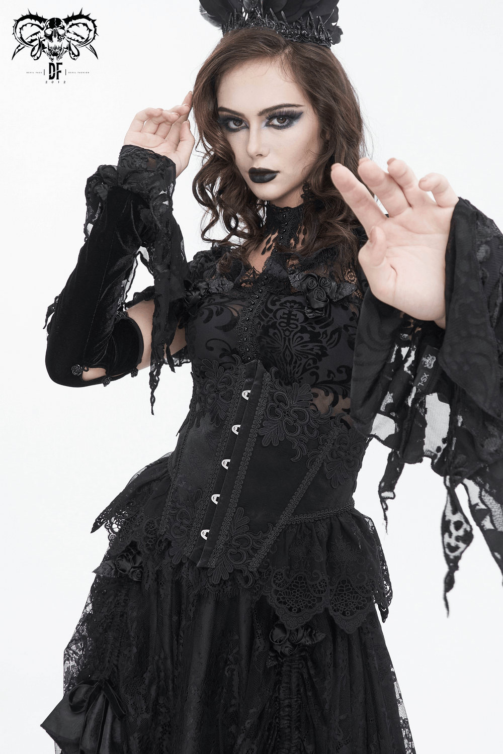Chic female model showcasing a black lace underbust corset with elegant floral embroidery and hook front closure.