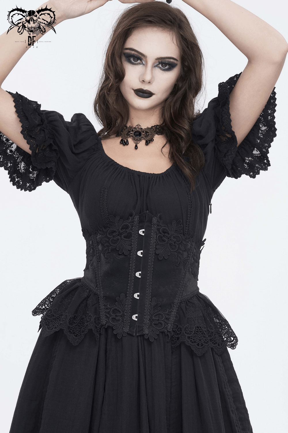 Chic female in a black lace underbust corset with floral embroidery and hook closure, exuding vintage elegance.