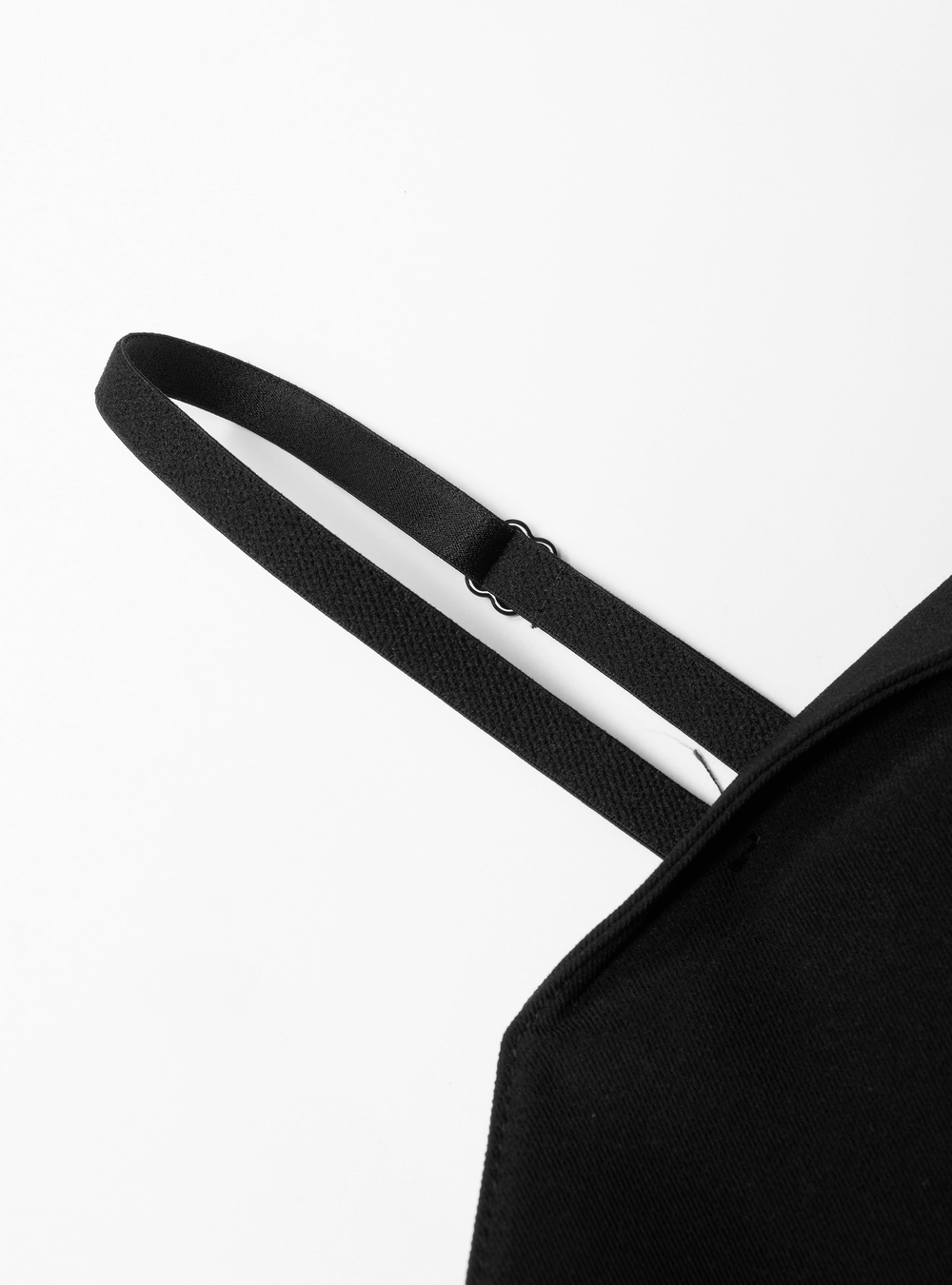 Close-up of a sleek black dress strap showcasing its adjustable design and soft texture.