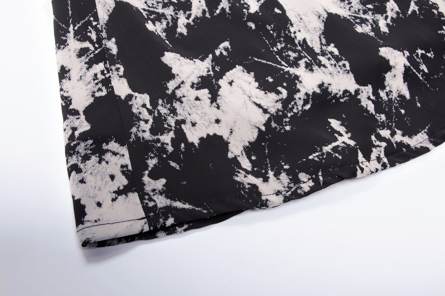 Chic black-and-white abstract flock pattern on soft fabric for a trendy A-line mini dress.