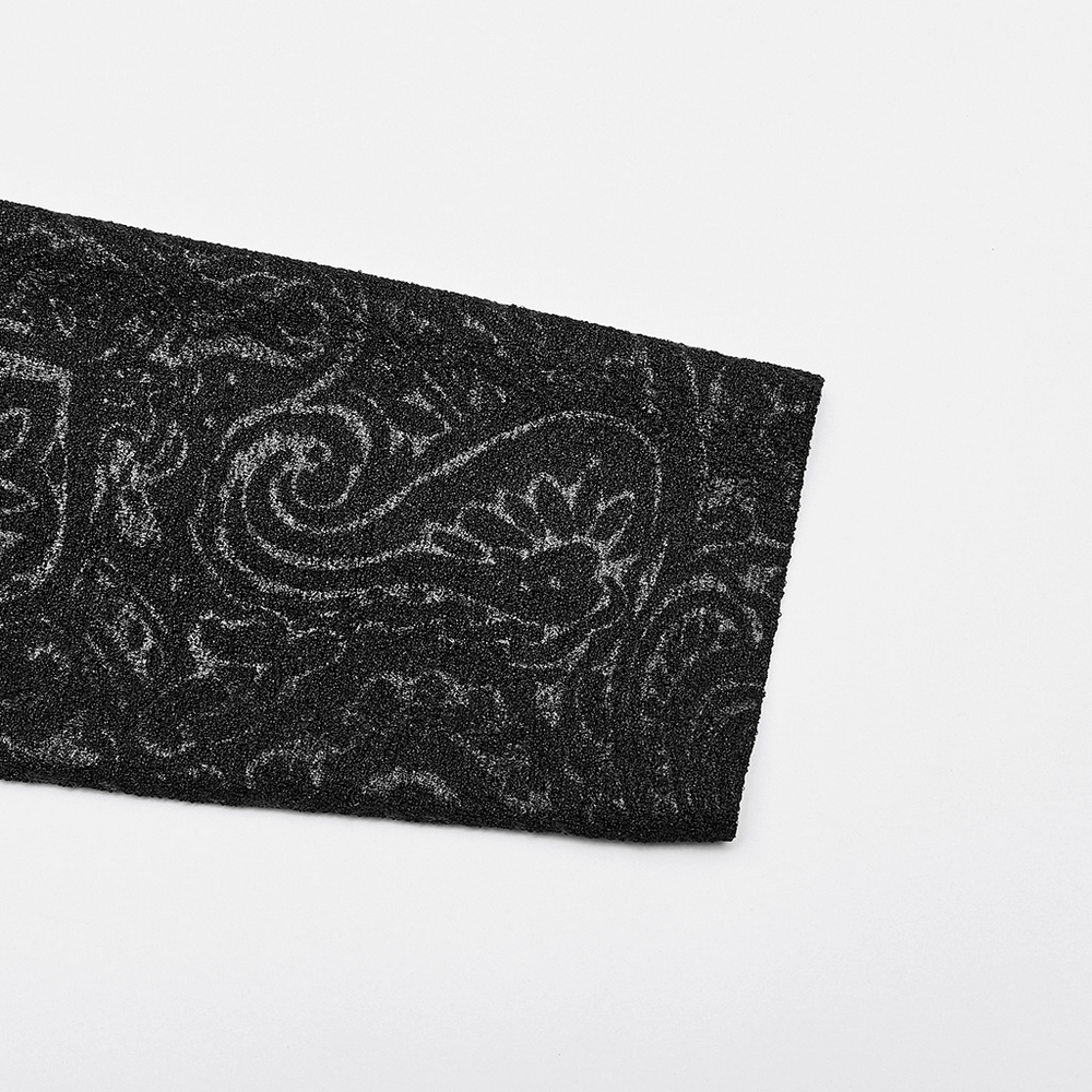 Close-up of luxurious black stretch jersey fabric with intricate gothic paisley design.