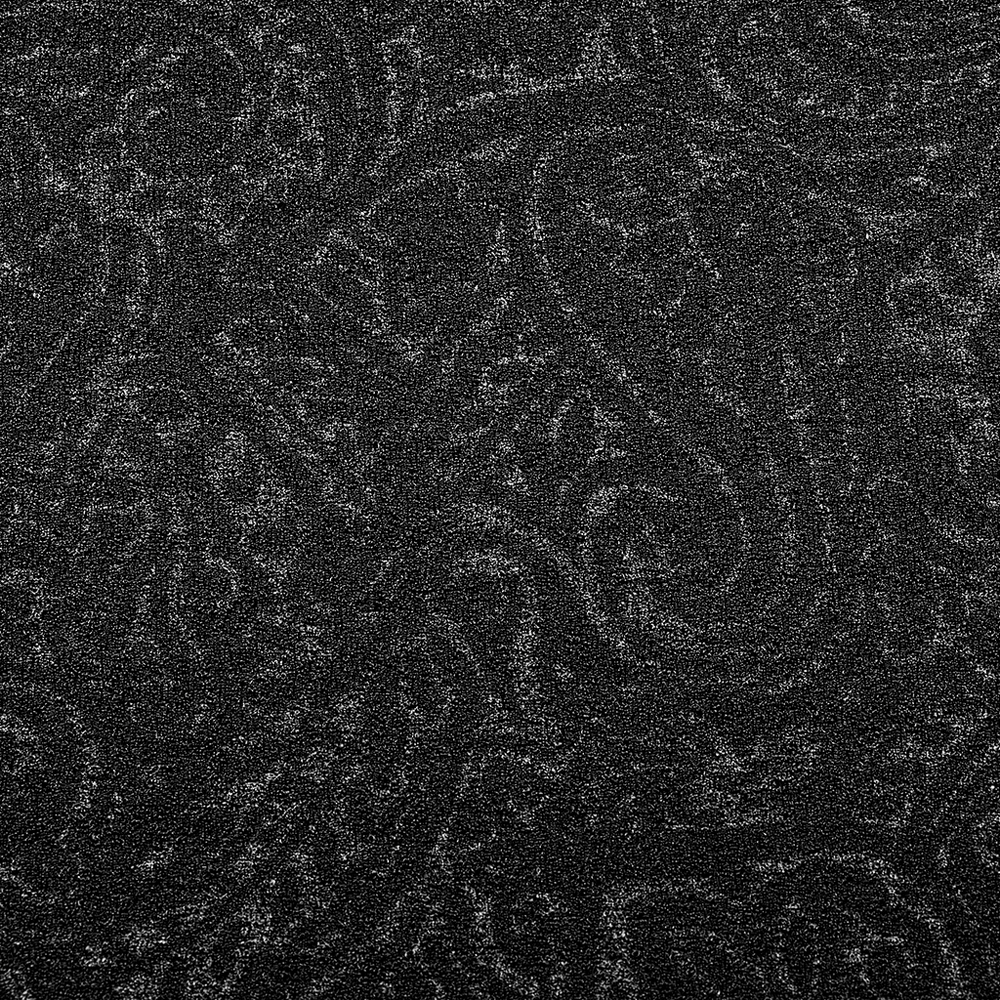 Close-up of textured black jersey fabric featuring a stylish paisley pattern, perfect for gothic fashion.