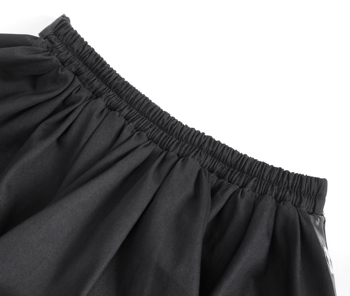 Close-up of the elastic waistband of a chic black gothic punk ruffle hem half skirt.