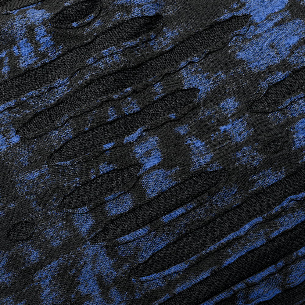 Close-up of a chic gothic knit fabric featuring rugged black and blue distressed patterns and cut-out details.