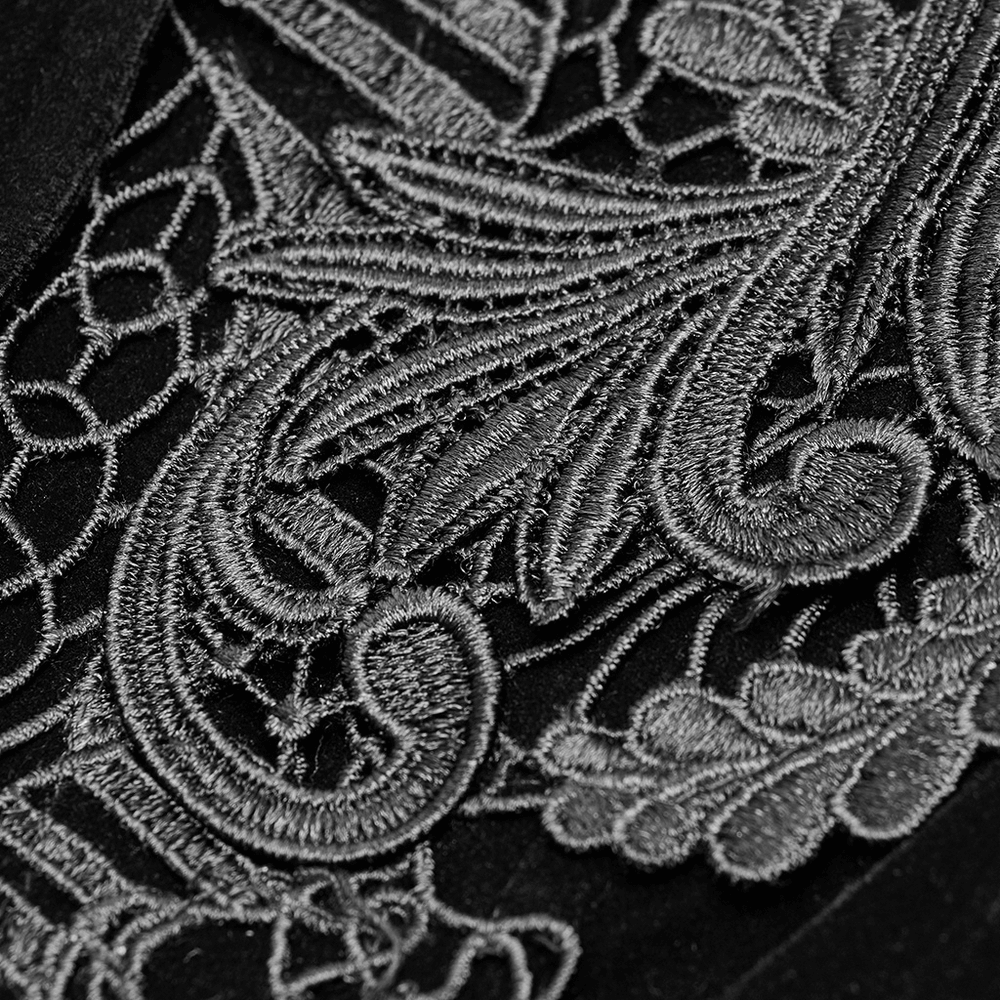 Intricate silver Gothic lace embroidery on black velvet, showcasing vintage charm and elegance.