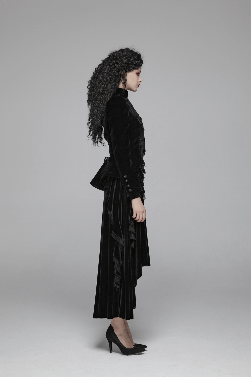 Side view of a model in a chic Gothic Weft Velvet Tailcoat with lace trim, showcasing elegant vintage charm.