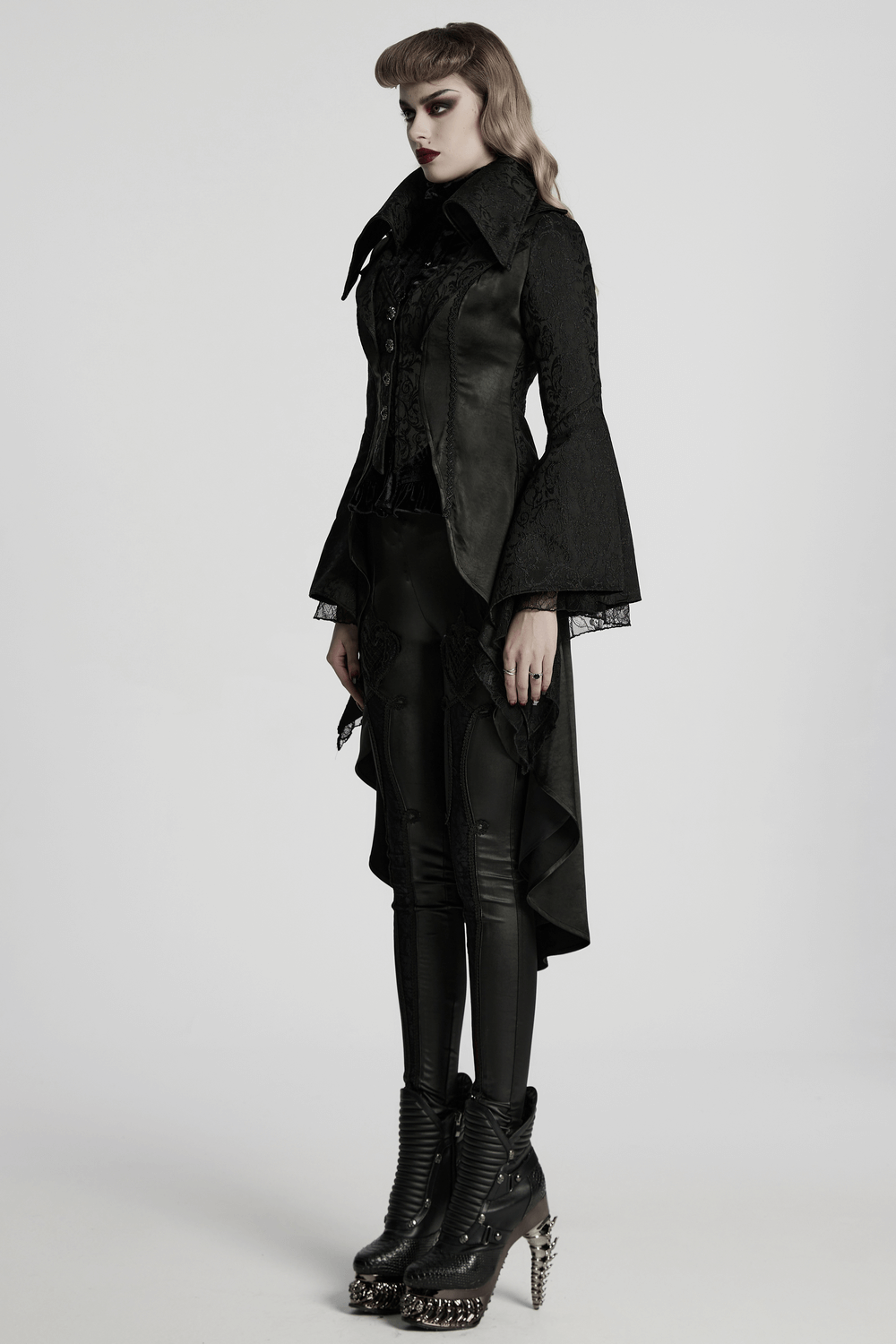 Chic high-low tailcoat featuring jacquard lace and buttons, paired with sleek pants and edgy boots for a stylish look.
