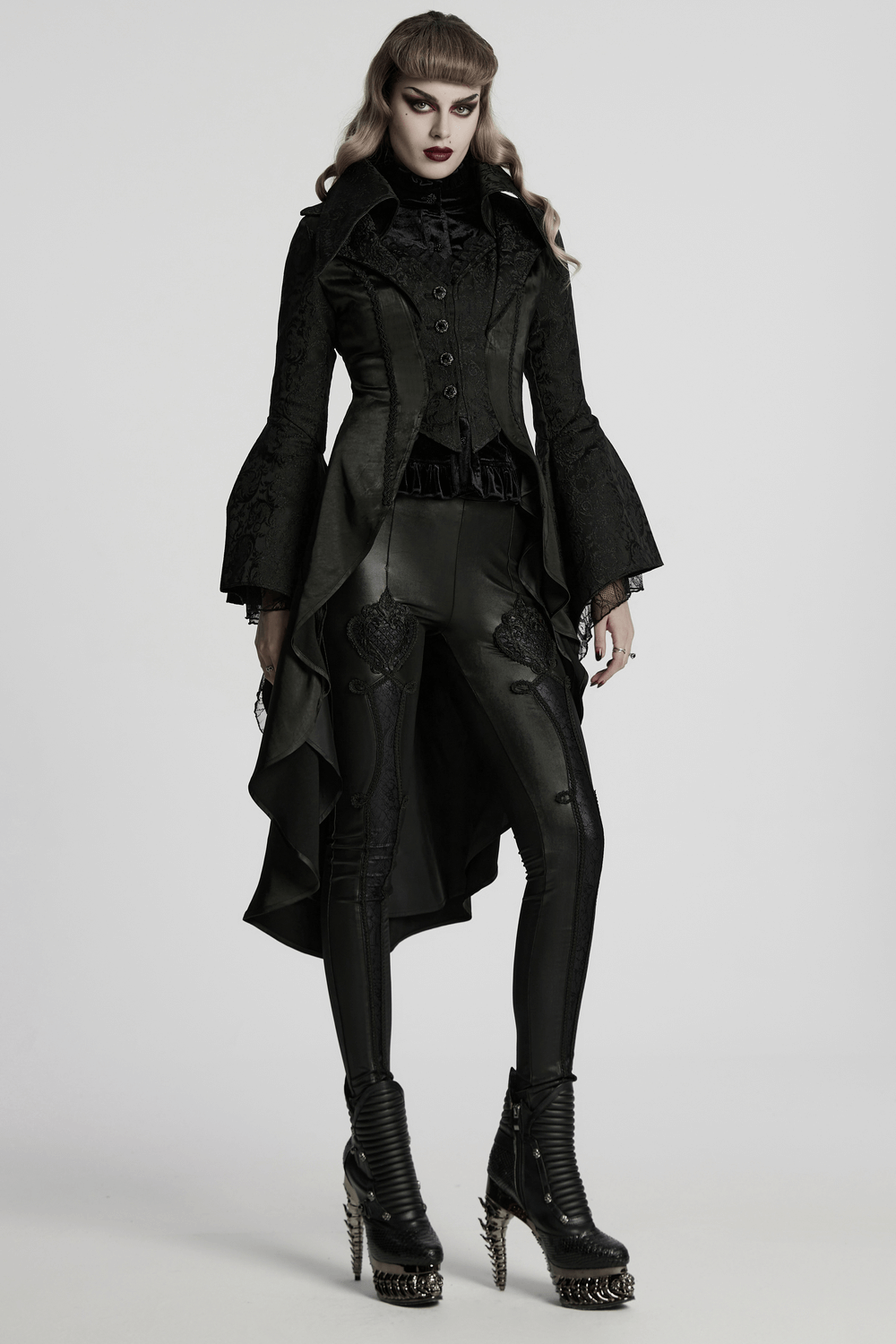 Chic high-low tailcoat with jacquard lace and buttons, styled with edgy black leggings and stylish boots.