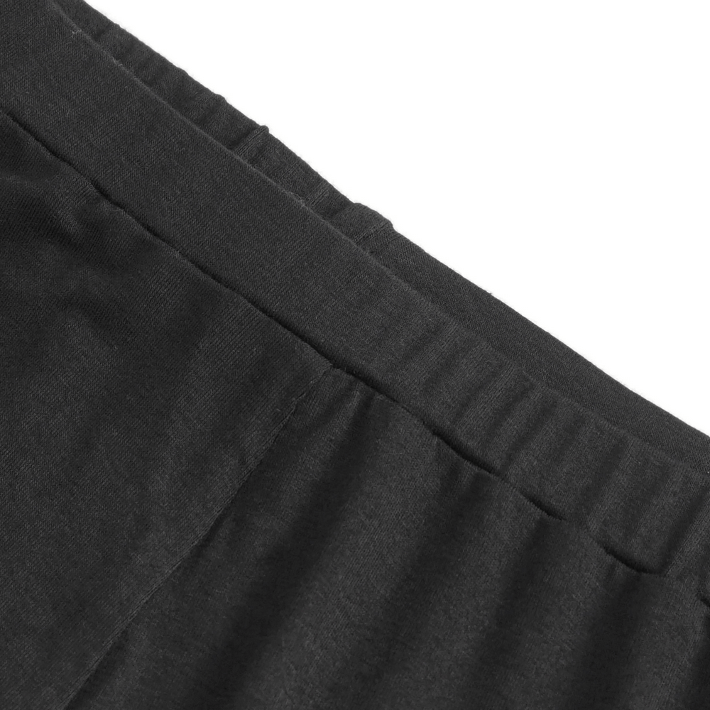 Close-up of the waistband of chic high-waisted black riveted shorts for women, showcasing its elastic design.