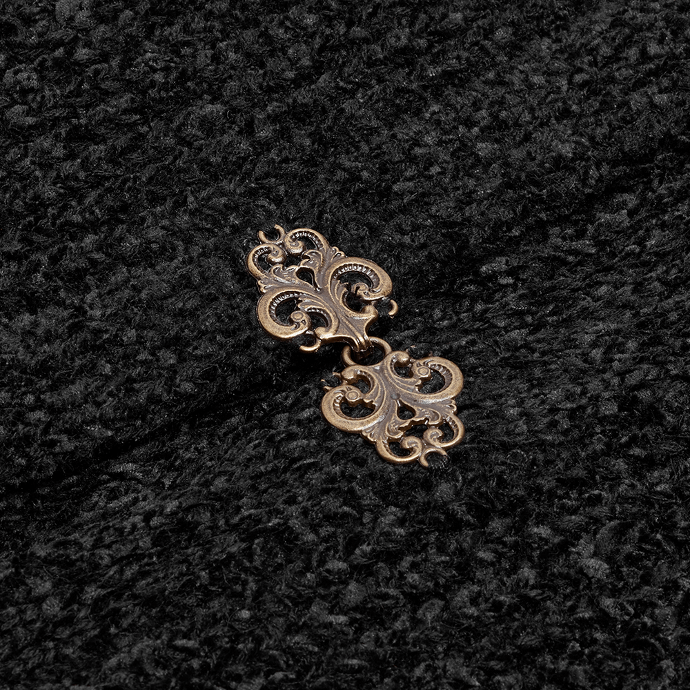 Intricate bronze clasp detail on luxurious black woolen cloak coat, showcasing gothic elegance.