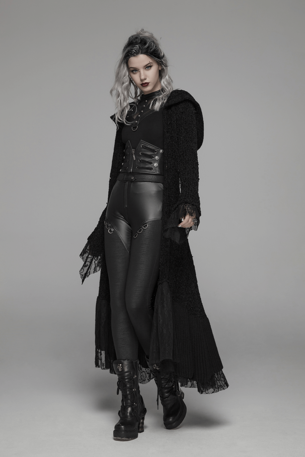 Chic hooded gothic lace trim woolen cloak coat styled with leather pants and boots, exuding gothic elegance.