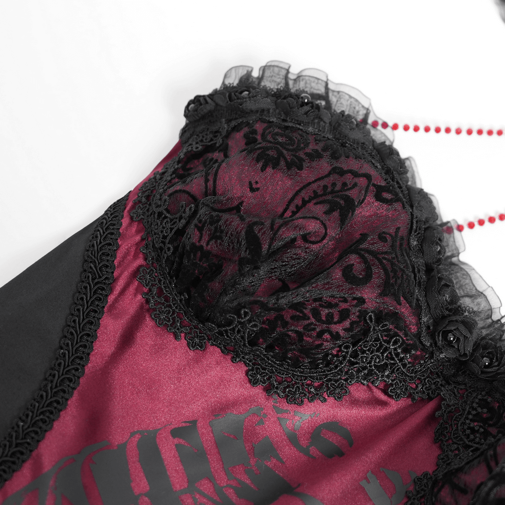 Close-up of chic lace and tulle gothic dress, showcasing intricate black lace details and rich burgundy fabric.