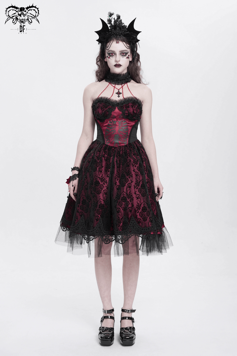 Gothic black and burgundy corset dress with lace and tulle, accentuated by striking skeleton print and bold accessories.