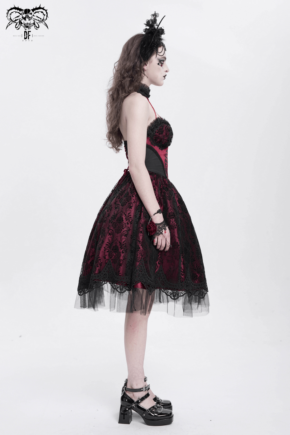 Chic black and burgundy gothic dress with lace and tulle, showcasing a skeleton print silhouette.