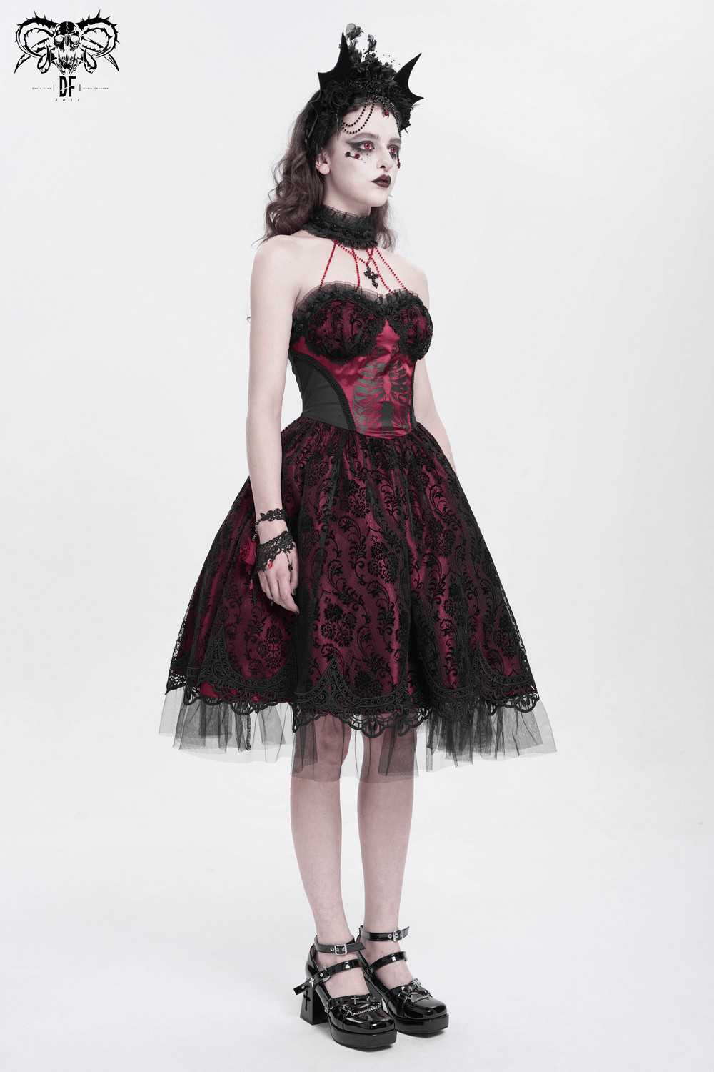 Chic gothic lace and tulle dress with skeleton print in black and burgundy, perfect for bold fashion statements.