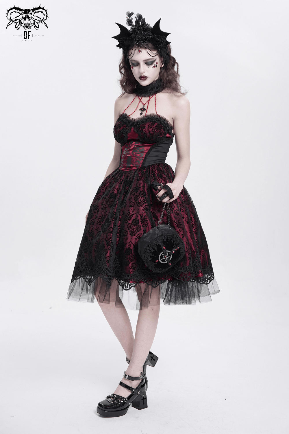 Gothic black and burgundy corset dress with lace, tulle skirt, and skeleton print, perfect for bold fashion statements.