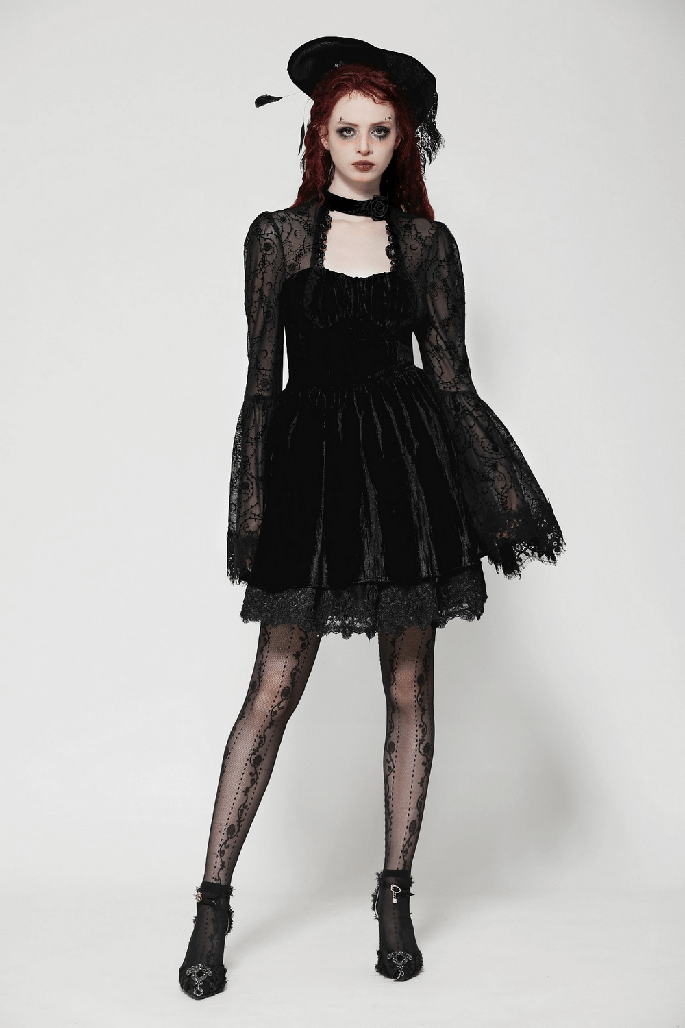 Elegant black lace gothic dress with flared sleeves, paired with accessories and dramatic fishnet stockings for a striking look.