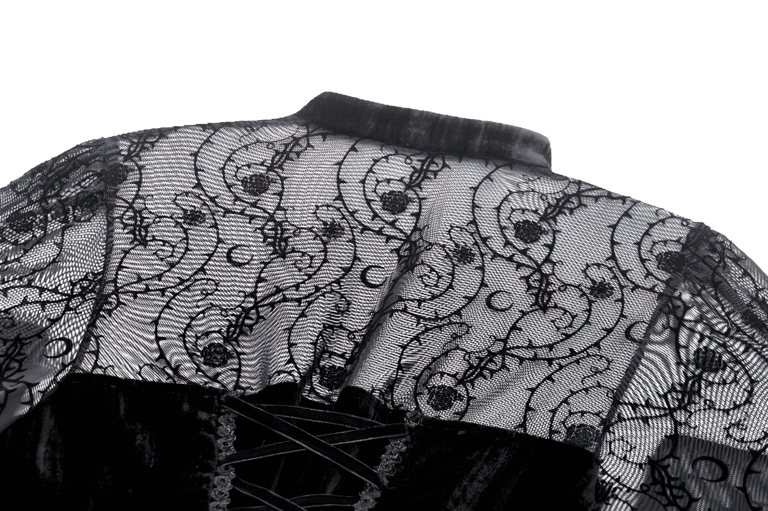 Intricate black lace detailing on the back of a gothic evening dress with elegant floral patterns.