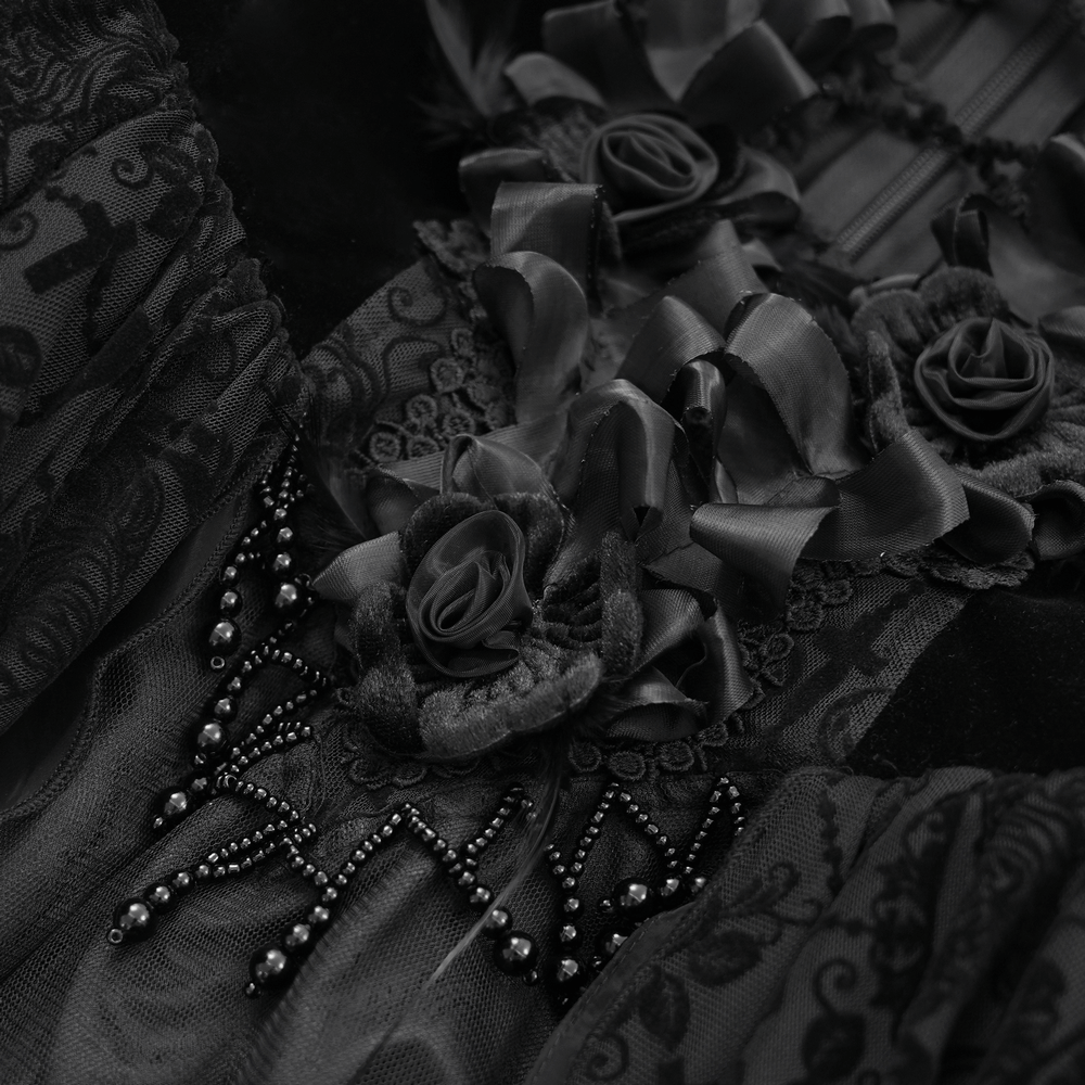 Elegant black lace dress detail with floral accents, ruffles, and intricate beadwork. Perfect for gothic style enthusiasts.