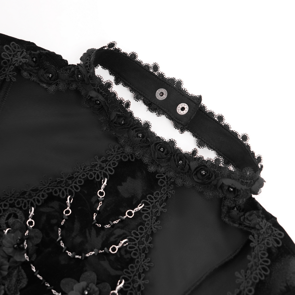 Detail of elegant black lace top featuring rose trim and pearl accents for a gothic-chic look.