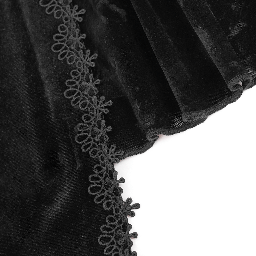 Close-up of black velvet fabric with delicate lace trim for an elegant gothic top with luxurious texture.
