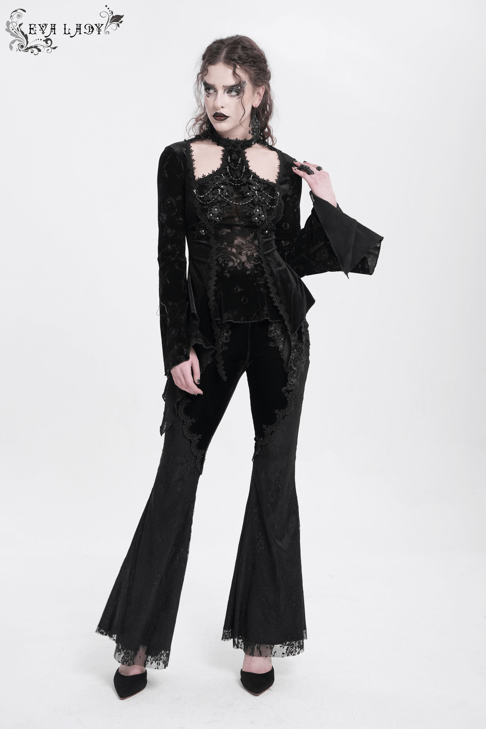 Chic Gothic long-sleeved top with lace and pearl details, paired with elegant black pants for a dramatic look.