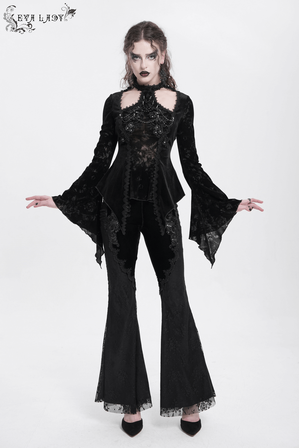 Elegant gothic model wearing a chic long-sleeved lace top with pearl embellishments and bell sleeves.