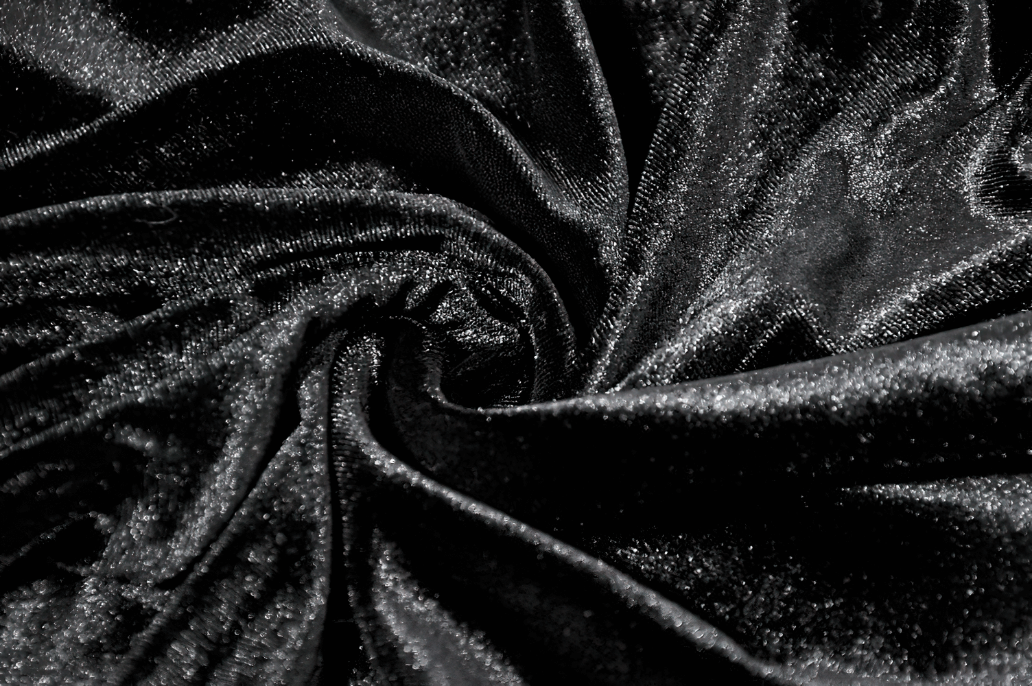 Chic Lace Mesh Panel Leggings with Floral Embroidery black velvet fabric close-up, showcasing a luxurious shiny texture.