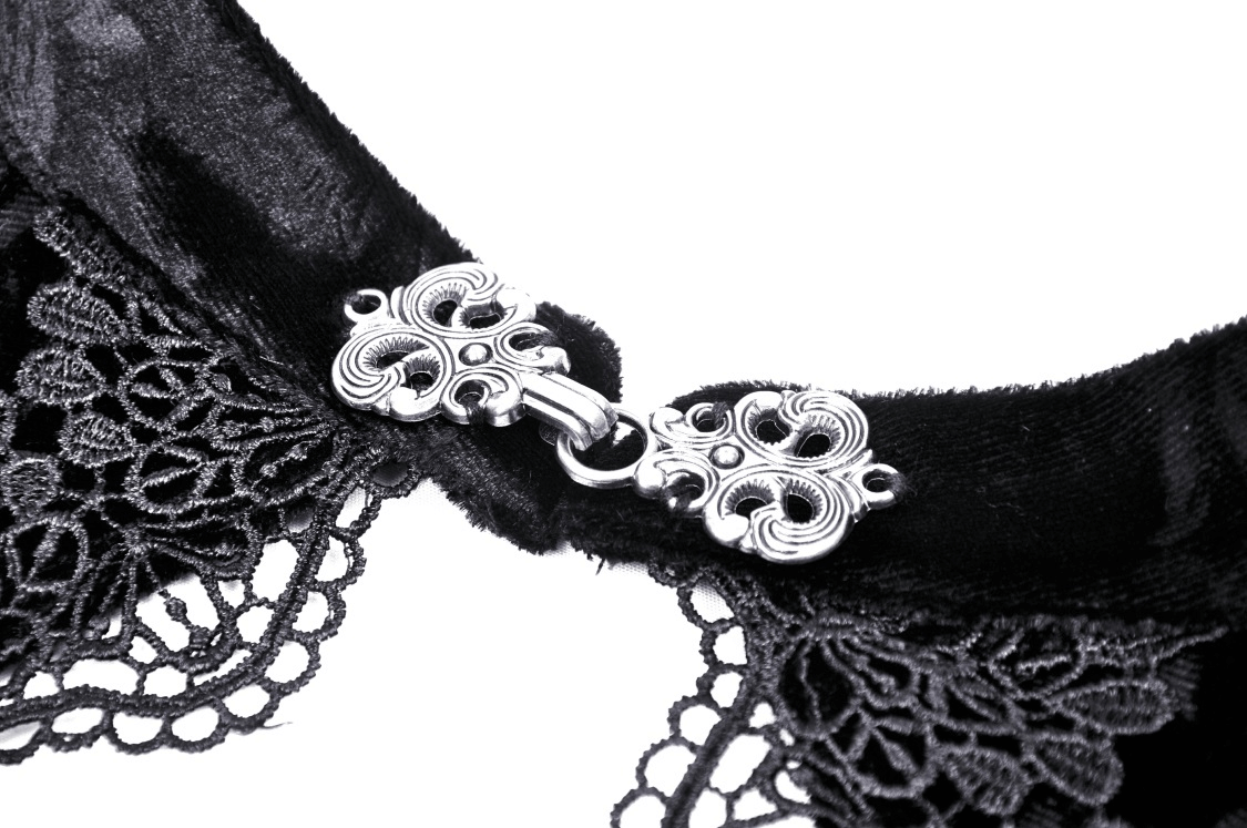 Close-up of intricate silver clasp on a black lace off-the-shoulder top, showcasing elegant detailing.