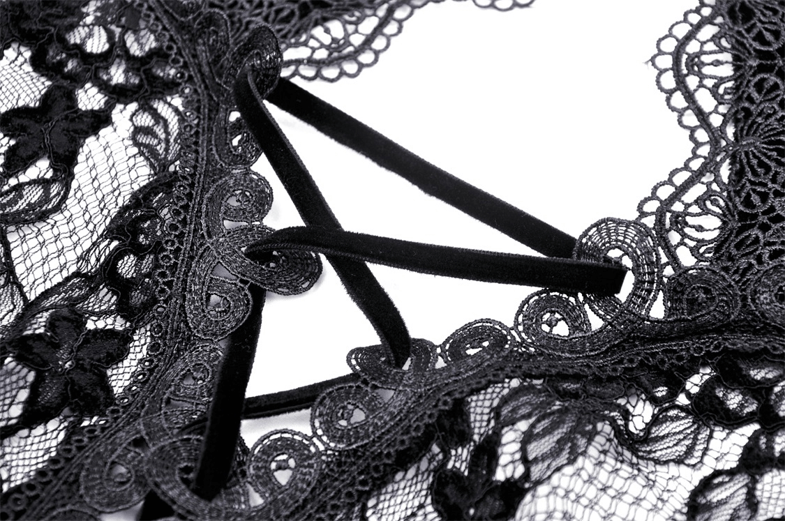 Close-up of intricate black lace pattern with stylish velvet detailing and elegant cutouts.