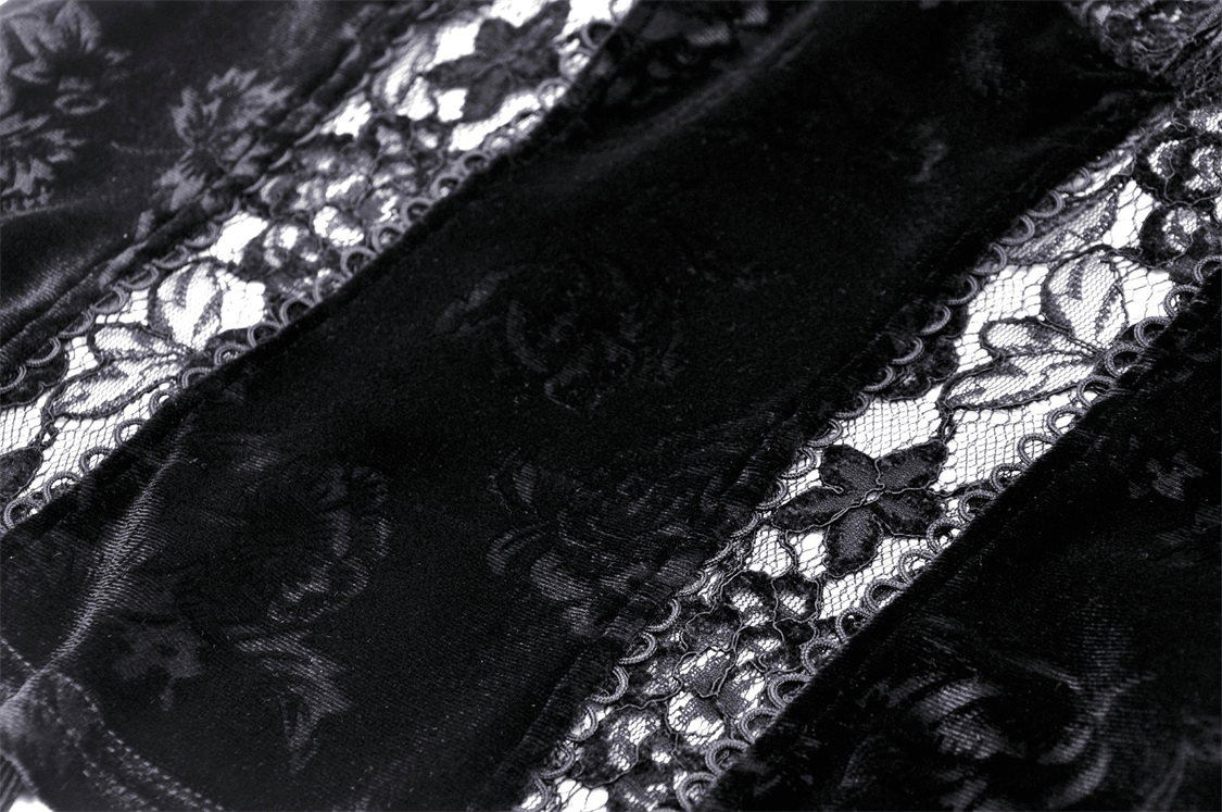 Close-up of intricate black lace with floral patterns, showcasing the elegance of a chic cold shoulder top.