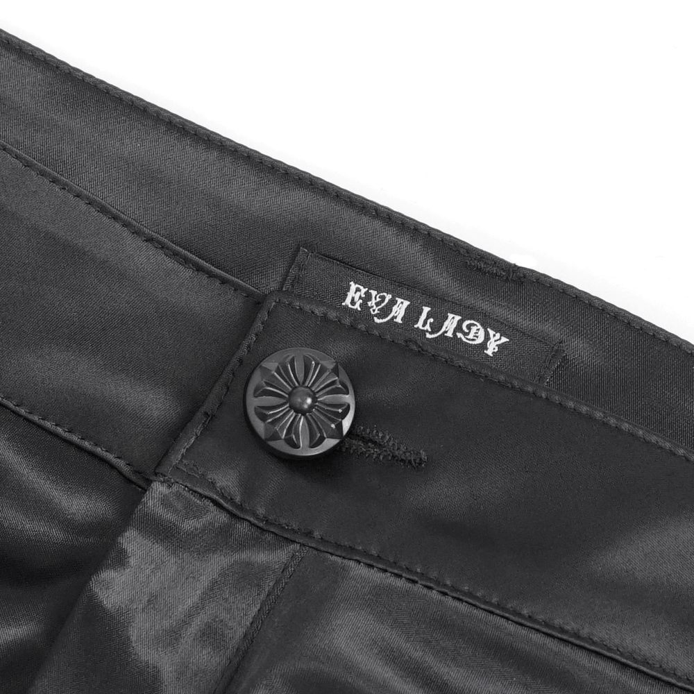 Close-up of chic black satin pants waistband with button and "EVA LADY" label.