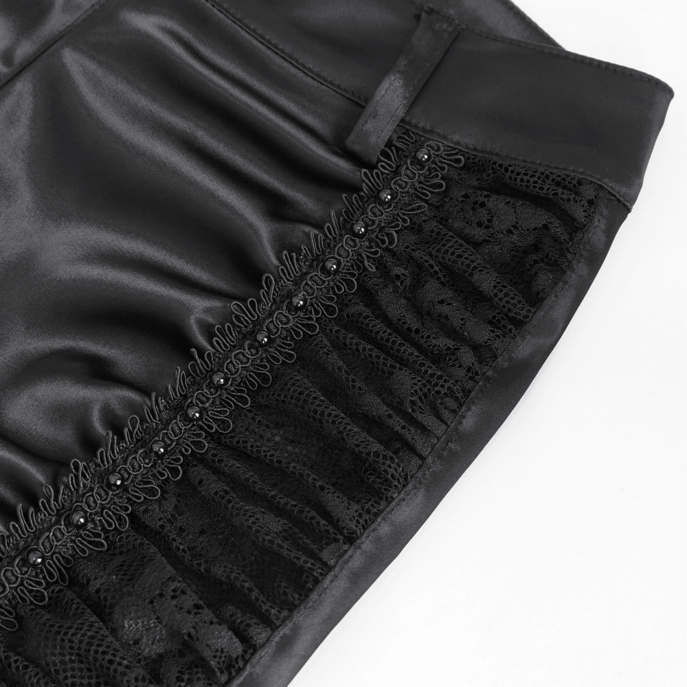 Close-up of black satin fabric with lace trim showcasing the elegant ruffle detail for gothic flared pants.