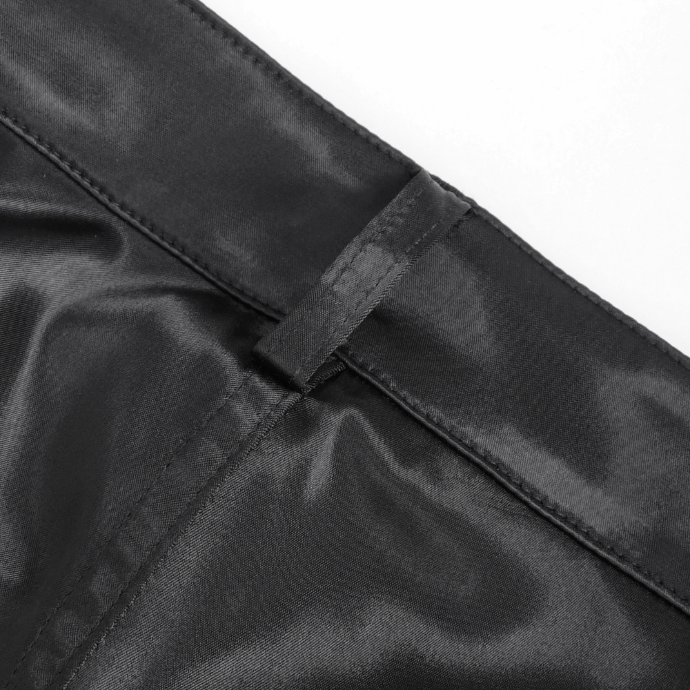 Close-up of sleek black satin waistband of chic lace-paneled flared pants for women.