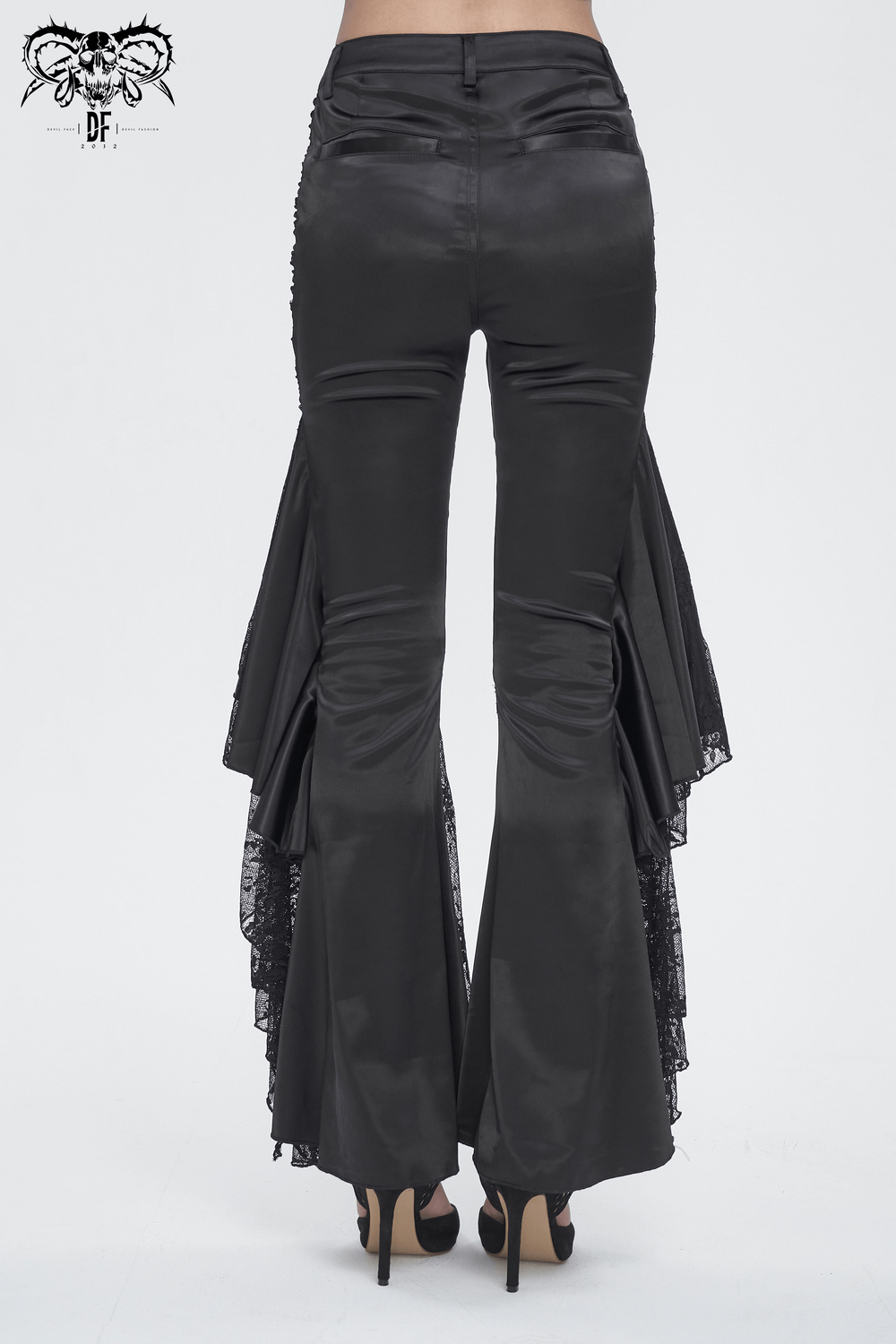 Chic black lace-paneled flared pants with dramatic ruffles for a gothic-inspired evening look.