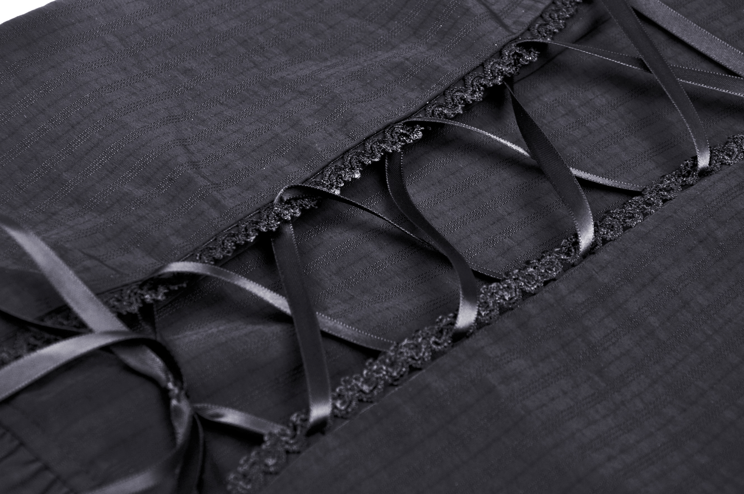 Close-up of black lace-trimmed blouse featuring intricate ribbon detailing and lace ruffles for a gothic look.